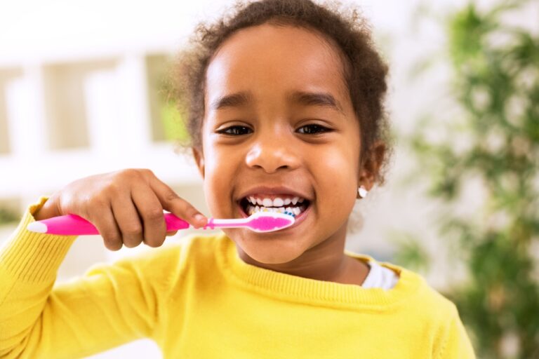 Little beautiful girl brushing teeth
