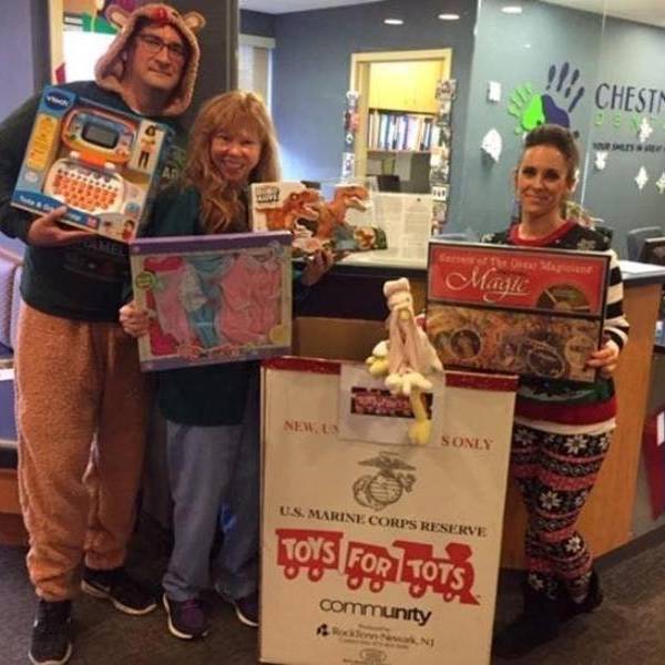 Our Needham office during our Ugly Sweater Day with our office Toys For Tots collection.