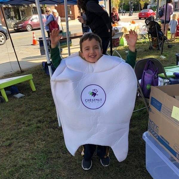 Dr. Amy Regen's son having fun as Timmy the Tooth, greeting visitors at the Needham Harvest Festival!