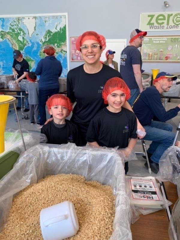 Dr. Amy Regen and her sons helping out at the Rise Against Hunger event hosted by the Bedford Rotary.