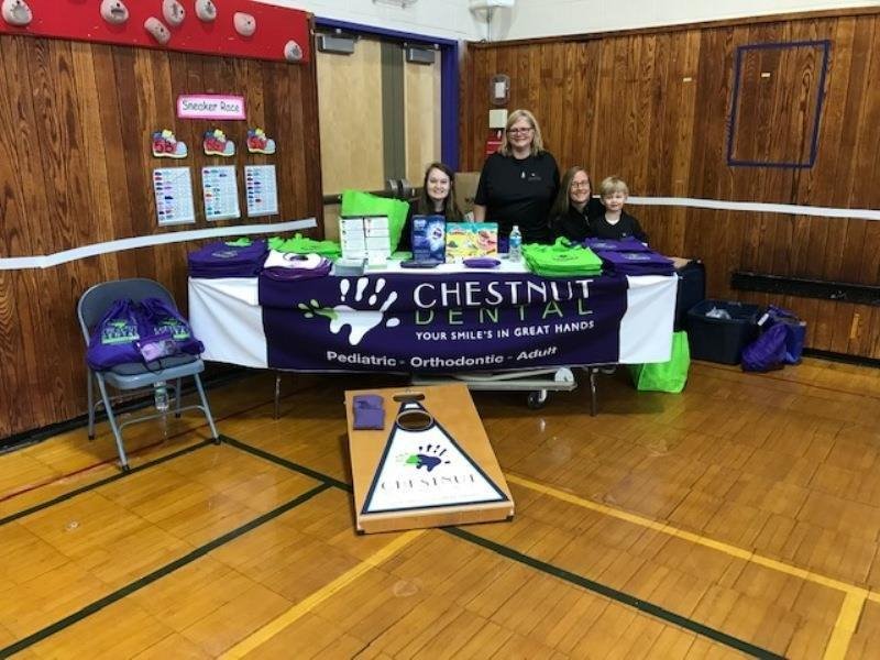 Dr. Keri Peterman along with her son and staff at the Charles River YMCA Healthy Kids Fair.
