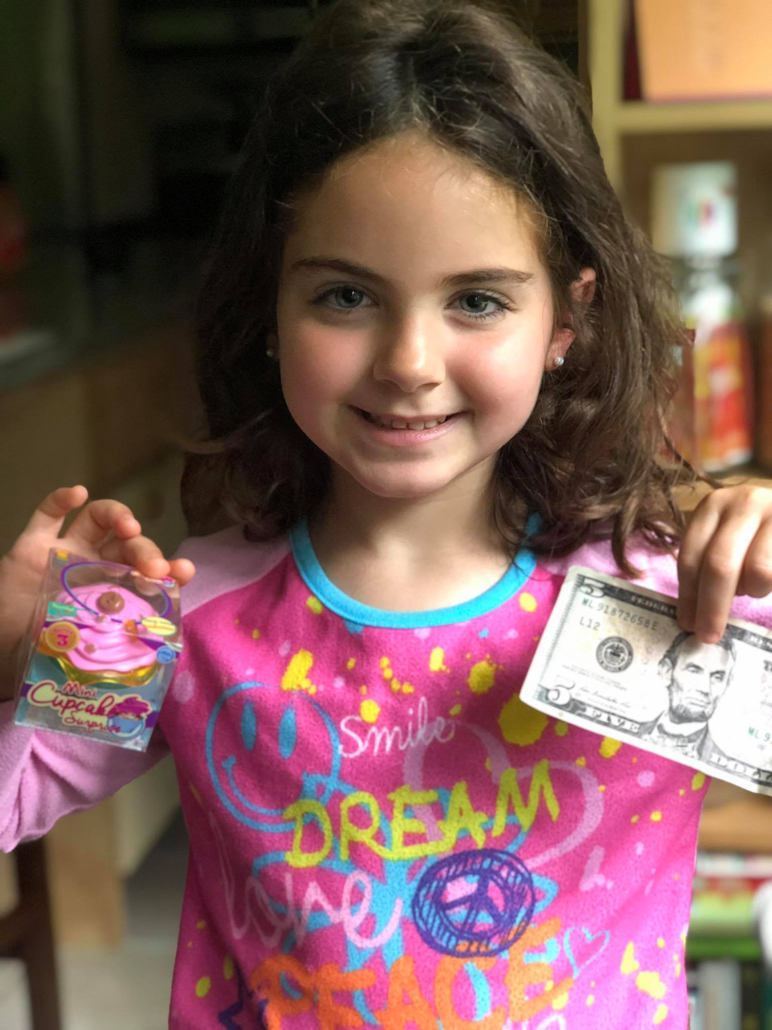 portrait of a girl holding money in hands