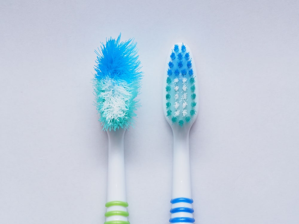 Old toothbrush next to new 